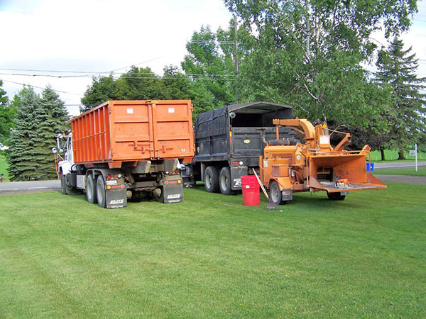 Two trucks and chipper